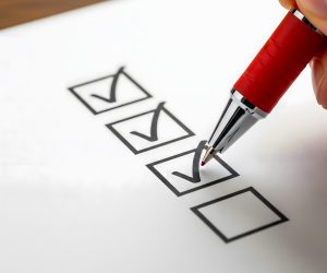 Kuvassa tsekkilista, johon kynällä merkattu väkäsiä.